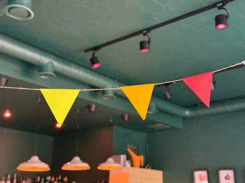 Colorful triangular pennant flags hanging in cafe interior. Celebration, joy, 写真素材
