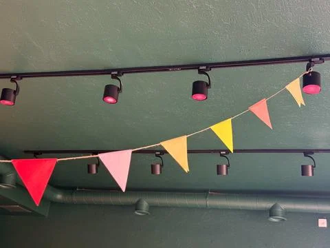Colorful triangular pennant flags hanging in cafe interior. Celebration, joy, 스톡 사진