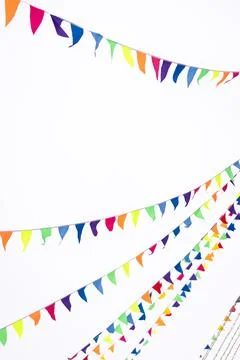 Colorful triangular pennant flags hanging against a bright sky, creating a .. 写真素材