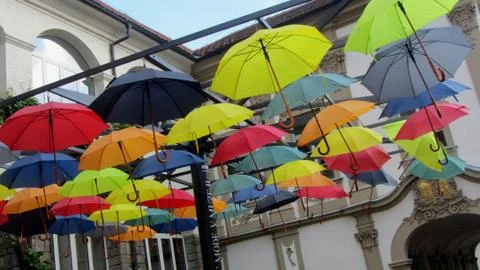 Colorful umbrella's hanging from a framework Stock Photos