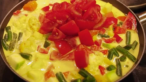 Colorful vegetable mixture cooking in a pan with fresh green and red elements Stock Footage 310692171