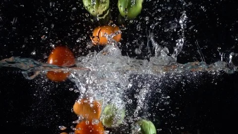 Colorful vegetables falling to water Stock Footage 82965587