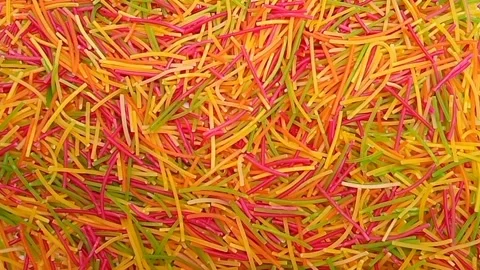 Colorful Vermicelli pasta rotating background. Dry uncooked Seviyan. Stock Footage 345383384