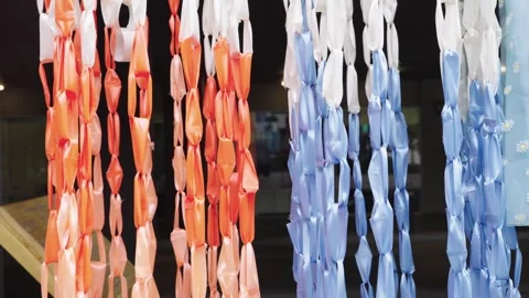 Colorful vertical streamers made of orange, white and blue plastic ribbons .. Video stock 342781924