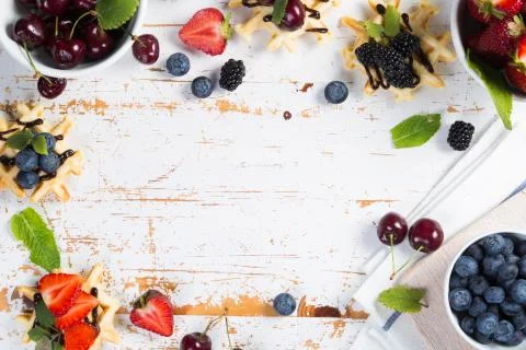 Colorful waffles with different berries Stock Photos
