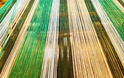 Colorful warp threads creating textile pattern on a loom Stock Photos