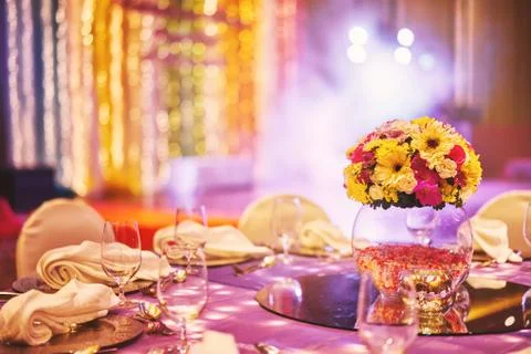 Colorful wedding reception dinner table decoration with flower bouquet Stock Photos