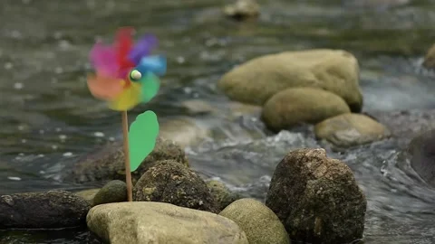Colorful windmill rotating in small streams. Stock Footage 141232319