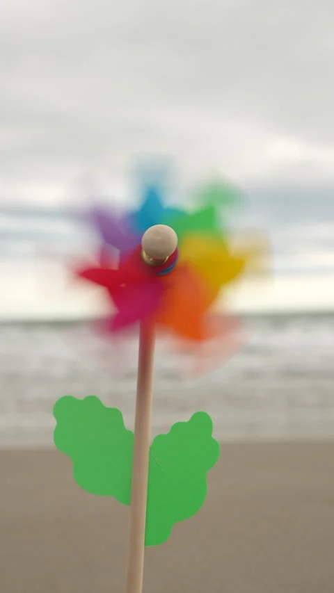 A colorful windmill is standing on the beach Stock Footage 276437055