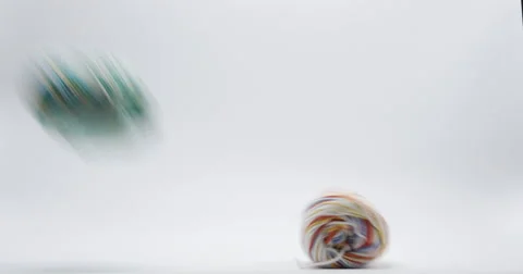 Colorful Yarn Rolls Falling on Ground Isolated on White, 4K Stock Footage 66192061