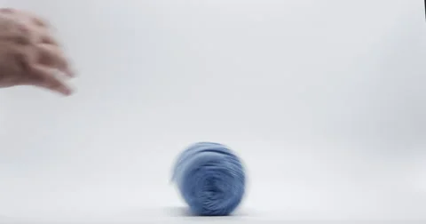 Colorful Yarn Rolls Rolling on Ground Isolated on White, 4K Stock Footage 66192489