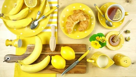 Colorful yellow theme breakfast brunch table setting flatlay stop motion. Stock Footage 112912415