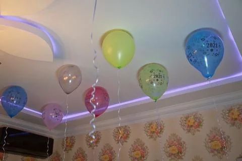Colorfull balloons float on the white ceiling in the room for the party. Wedd Stock Photos