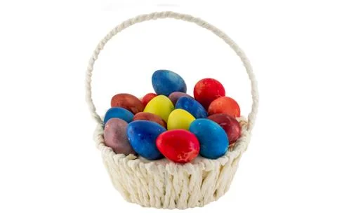 Colorfull Easter eggs in wicker basket isolated on white background Stock Photos