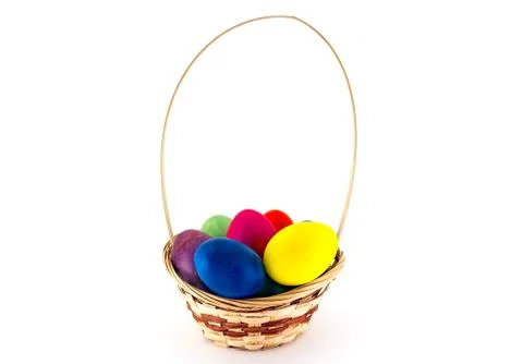 Colorfull Easter eggs in wicker basket isolated on white background Stock Photos