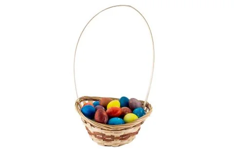 Colorfull Easter eggs in wicker basket isolated on white background Stock Photos