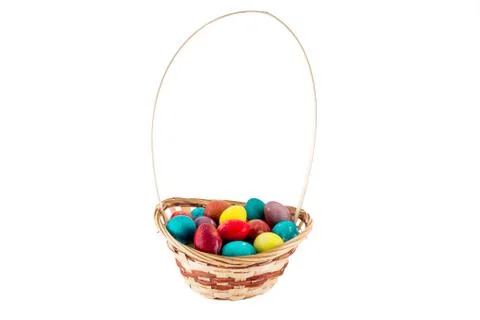 Colorfull Easter eggs in wicker basket isolated on white background Stock-Fotos