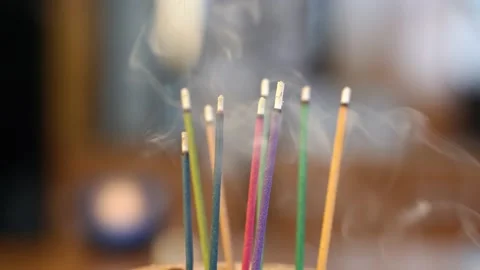 Colorfull incense burning on table Stock Footage 138371839