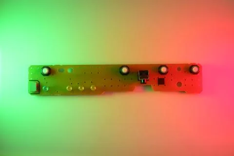 Colorfully Lit Circuit Board PCB With Microchip and Connectors on Gradient .. Stock Photos