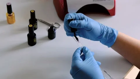 Coloring artificial fake nails sample template with shellac UV gel Stock Footage 131111739