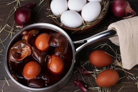 Coloring chicken eggs for Easter with onion peel. Stock Photos