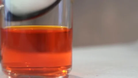 Coloring Easter eggs for the holiday. Man lowers white chicken egg into dye Stock Footage 128950133