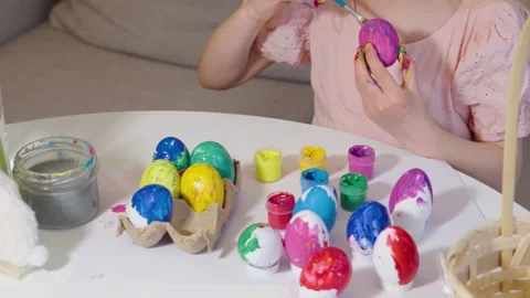 Coloring Easter eggs with joyful creativity and vibrant colors Stock Footage 302043836