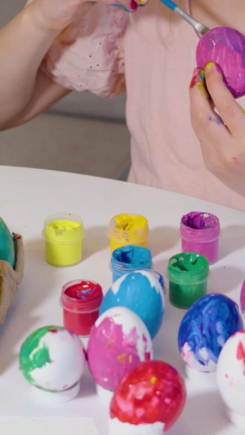 Coloring Easter eggs with joyful creativity and vibrant colors Stock Footage 302069317