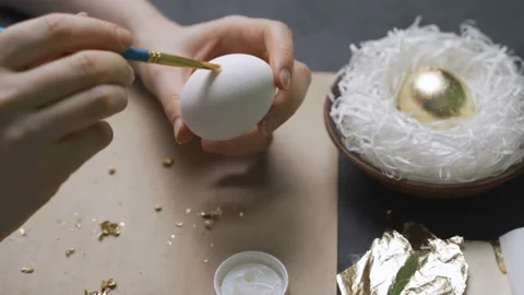 Coloring eggs for Easter with hands and a brush with watercolor paints. Nest and Stock Footage 103141851