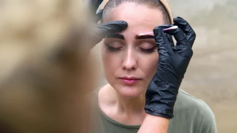 Coloring eyebrows on the banks of the river. Stock Footage 202010257