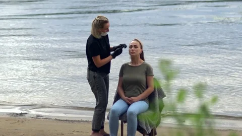 Coloring eyebrows on the banks of the river. Stock Footage 202010411