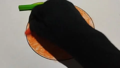 Coloring a picture of an orange using an orange crayon Stock Footage 224974883
