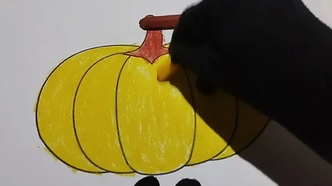 Coloring pictures of walo fruit using yellow and brown crayons Stock Footage 224966822