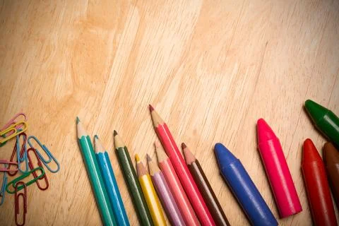 Coloring tools are lying on flat design wooden table with colored pencils, イラスト素材