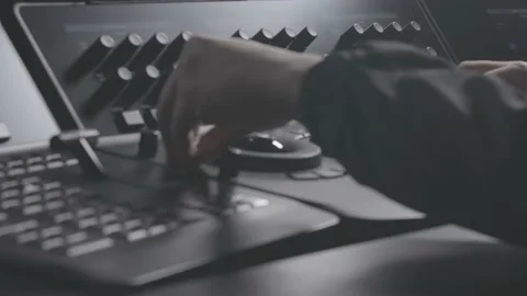 A colorist operating a color grading panel and console Stock Footage 159778348
