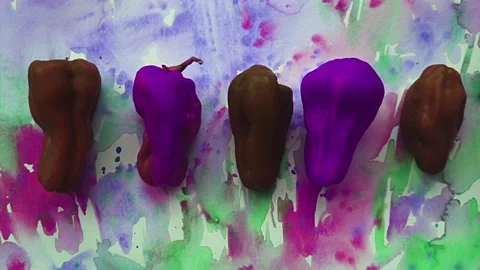 Colorized peppers set against grungy style backgound Stock Footage