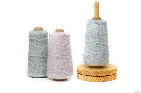 Colors of creativity dance on spools as soft threads twirl in a gentle embr.. Stock Photos
