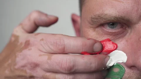 The colors on the face of a fanatical man. Stock Footage 274977986
