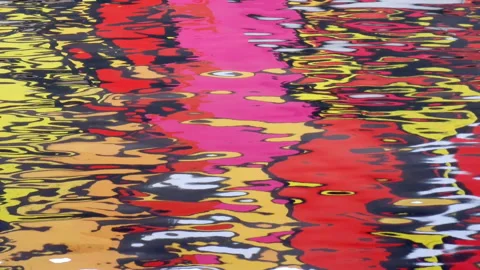 Colors reflected in rippled water surface - colorful red, pink and yellow wall Stock-Footage 232101041
