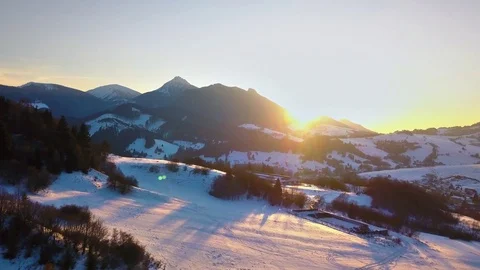 Colors of sunset over winter mountains and rural country Aerial view Video stock 124528355