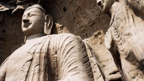 Colossal Ancient Buddha Statue Carved Into Sandstone Cliff Face Vidéo 339080040