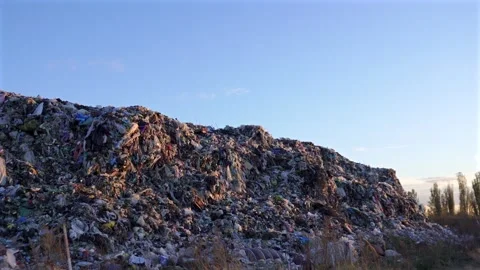 A colossal heap of varied discarded items extends widely under an expansive.. Stock Footage 321918178