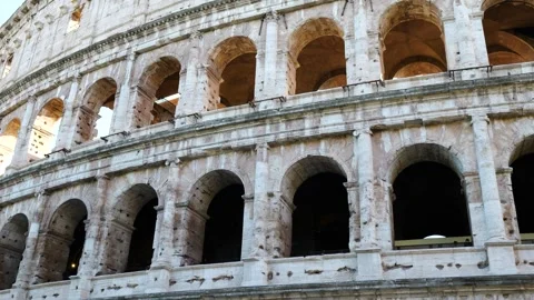 Colosseum repeating stone arches columns pockmarked travertine layered arcades Stock Footage 324919066