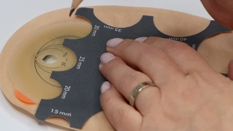 Colostomy bag, supply needed after colostomy surgery. Drawing hole for cutting Stock Footage 122122667