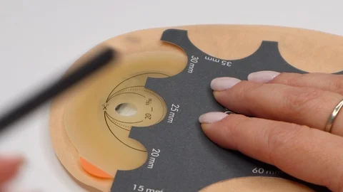 Colostomy bag, supply needed after colostomy surgery. Drawing hole for cutting Stock Footage 122126896