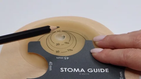 Colostomy bag, supply needed after colostomy surgery. Drawing hole for cutting Stock Footage 122127600