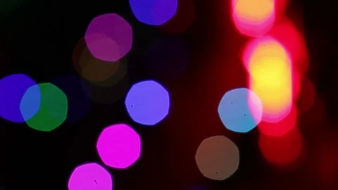 Colour-changing bokeh with red and orange spots blending together on and off Stock Footage 83800247