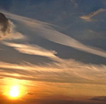 Colour clouds at sunset Stock Photos