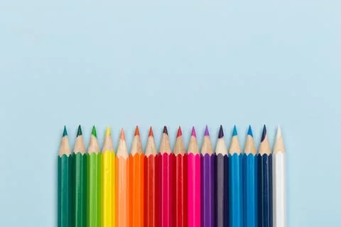 Colour pencils on blue background Stock Photos