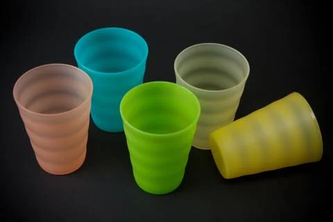 Colour plastic glasses on dark background Stock Photos